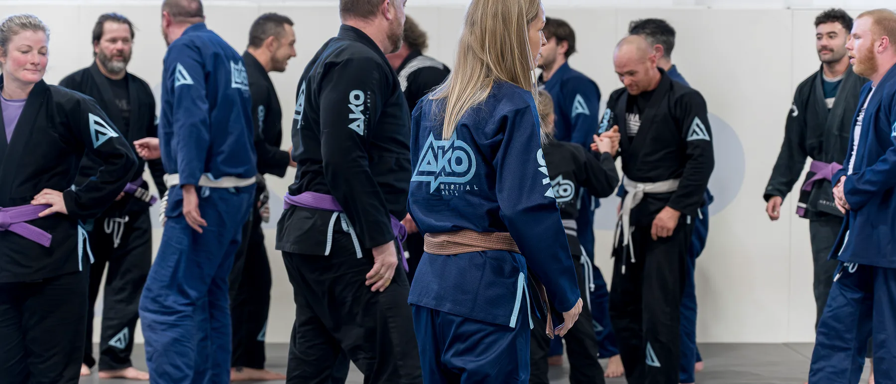 An adult class at Ako Martial Arts — women and men training together on the mats
