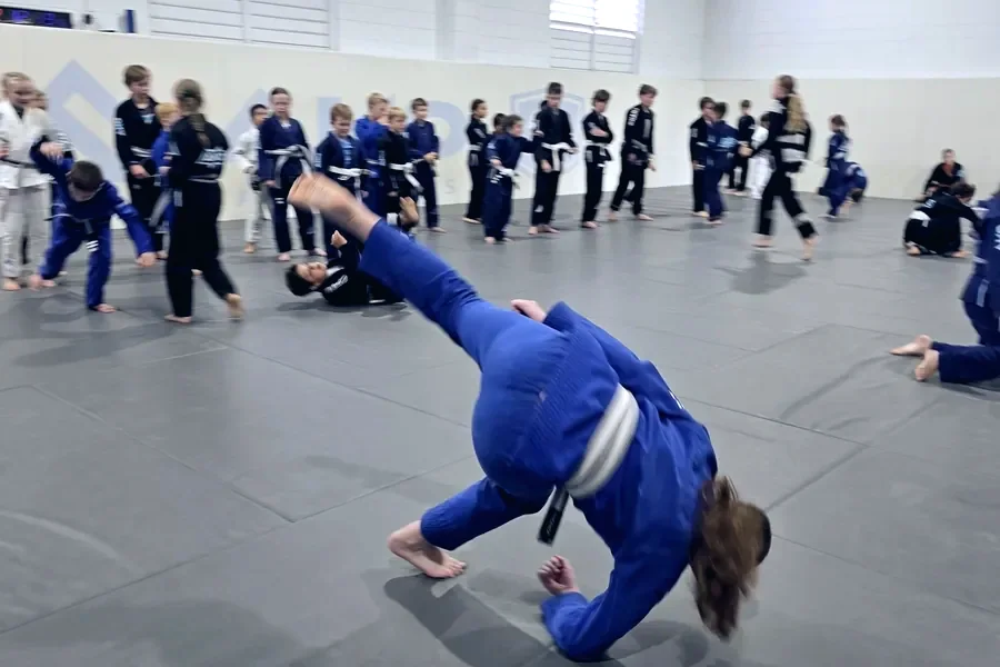 A junior Judo class practising throws and breakfalls on the mats at Ako Martial Arts